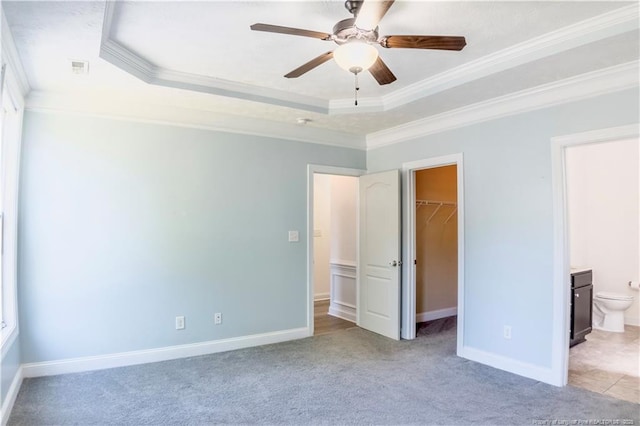 37 Annapolis Rd, Cameron, NC 28326 - unfurnished bedroom with a tray ceiling, ornamental molding, a spacious closet, light carpet, and ensuite bathroom