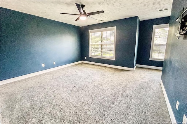 37 Annapolis Rd, Cameron, NC 28326 - carpeted spare room with ceiling fan, plenty of natural light, a textured ceiling, and a textured wall