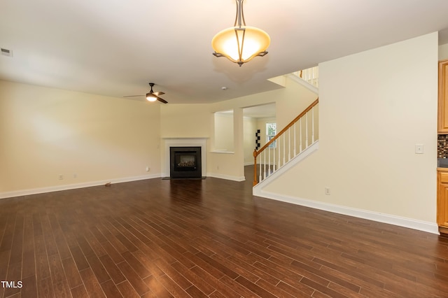 418 Byrams Ford Dr, Cary, NC 27513 - unfurnished living room featuring stairs, ceiling fan, dark wood-type flooring, and a fireplace