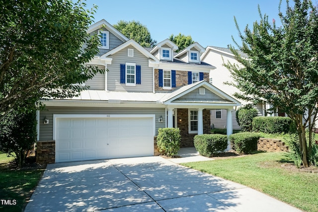 418 Byrams Ford Dr, Cary, NC 27513 - view of front facade with stone siding, driveway, covered porch, a garage, and a front lawn