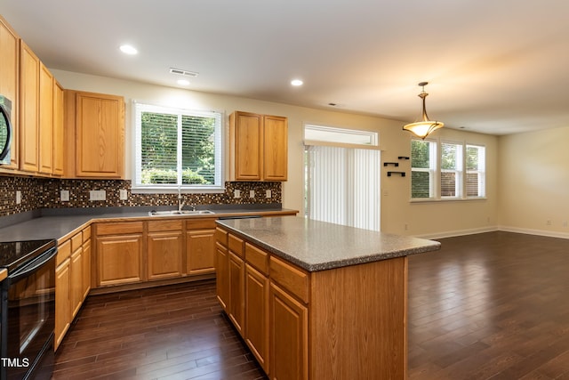 418 Byrams Ford Dr, Cary, NC 27513 - kitchen with black / electric stove, dark wood-style floors, tasteful backsplash, a center island, and recessed lighting