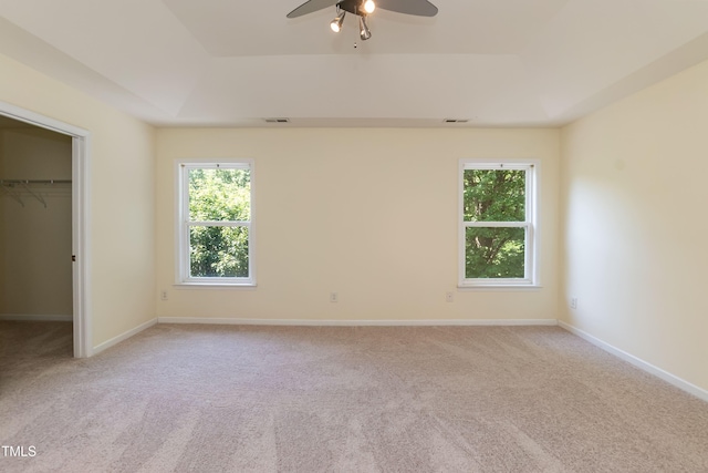 418 Byrams Ford Dr, Cary, NC 27513 - unfurnished bedroom with a raised ceiling, a spacious closet, light carpet, a closet, and ceiling fan