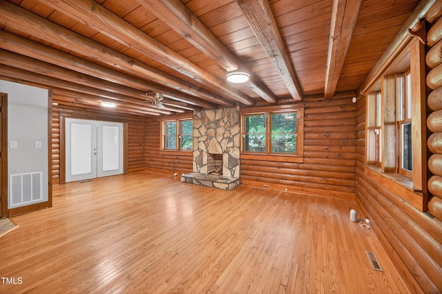 3263 S Jim Minor Rd, Haw River, NC 27258 - spare room featuring a stone fireplace, light wood finished floors, rustic walls, a wooden ceiling with exposed beams, and french doors