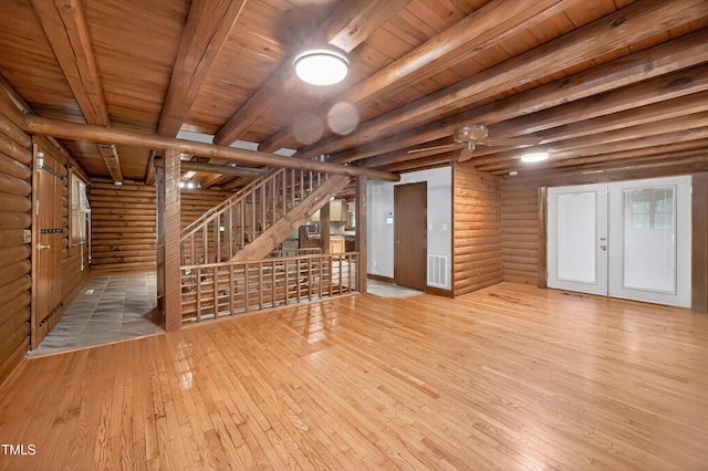 3263 S Jim Minor Rd, Haw River, NC 27258 - unfurnished living room featuring log walls, a wood ceiling with exposed beams, hardwood / wood-style floors, and french doors