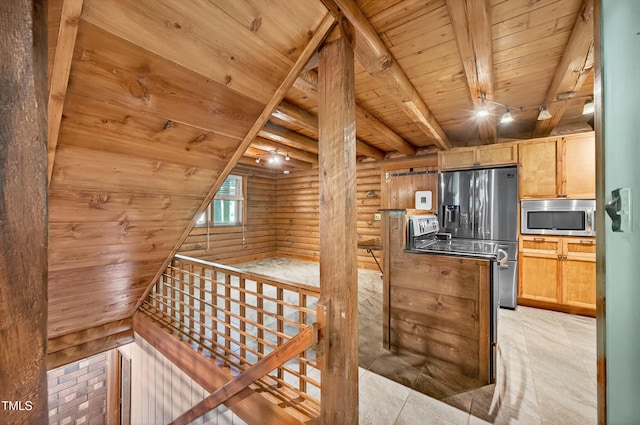 3263 S Jim Minor Rd, Haw River, NC 27258 - kitchen featuring appliances with stainless steel finishes, a wooden ceiling with exposed beams, rustic walls, and light brown cabinetry