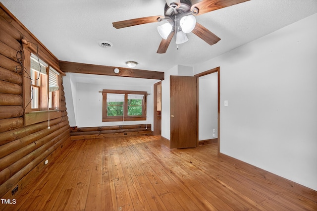 3263 S Jim Minor Rd, Haw River, NC 27258 - spare room with rustic walls, light wood-style flooring, healthy amount of natural light, a textured ceiling, and ceiling fan