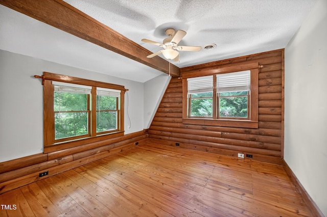 3263 S Jim Minor Rd, Haw River, NC 27258 - spare room with rustic walls, hardwood / wood-style floors, ceiling fan, and a textured ceiling