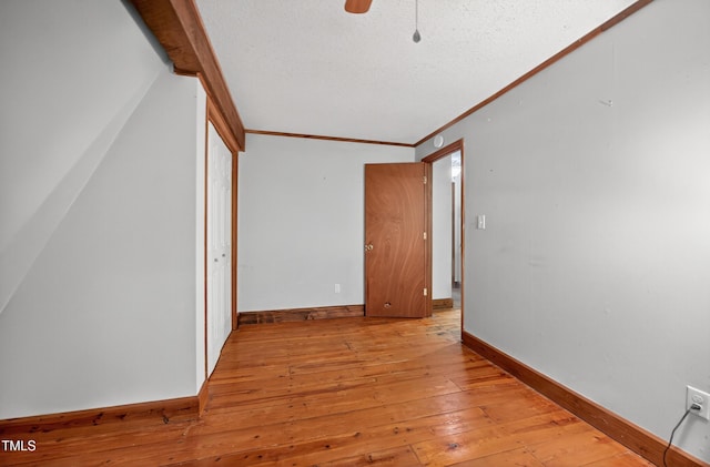 3263 S Jim Minor Rd, Haw River, NC 27258 - unfurnished room with light wood-style floors, a textured ceiling, crown molding, and a ceiling fan