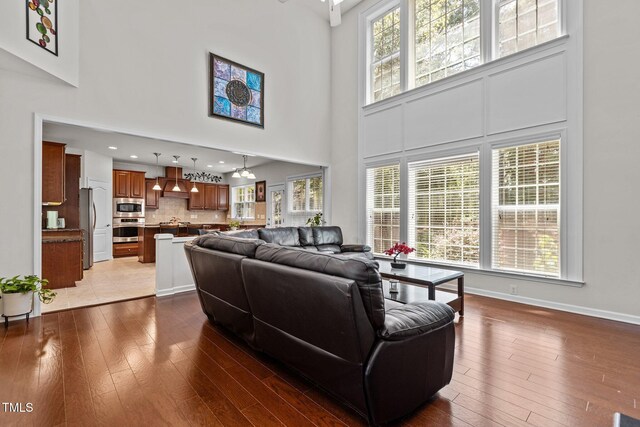 308 Sutton Glen Dr, Apex, NC 27523 - living room featuring a high ceiling, hardwood / wood-style flooring, and recessed lighting