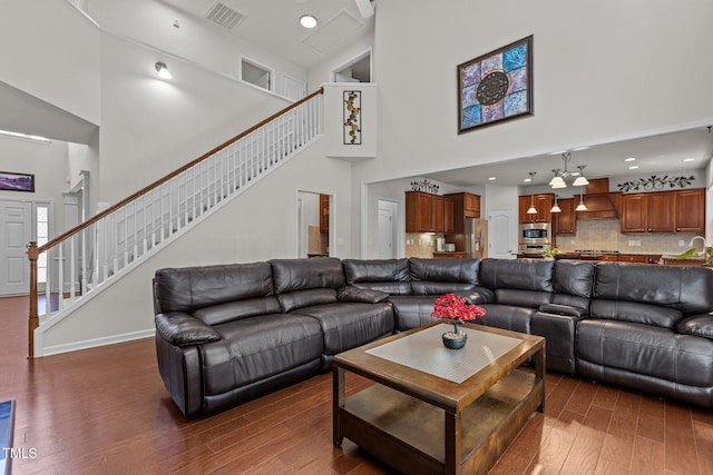 308 Sutton Glen Dr, Apex, NC 27523 - living area with high vaulted ceiling, dark wood-style floors, stairway, and recessed lighting