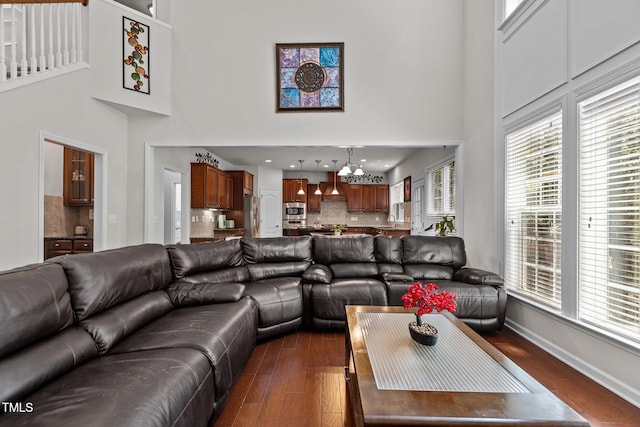 308 Sutton Glen Dr, Apex, NC 27523 - living area featuring a high ceiling, a chandelier, and dark wood finished floors