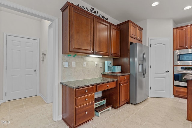 308 Sutton Glen Dr, Apex, NC 27523 - kitchen with stainless steel appliances, backsplash, dark stone counters, light tile patterned floors, and recessed lighting