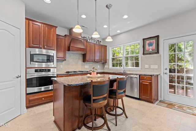 308 Sutton Glen Dr, Apex, NC 27523 - kitchen with appliances with stainless steel finishes, premium range hood, decorative backsplash, a breakfast bar, and a center island