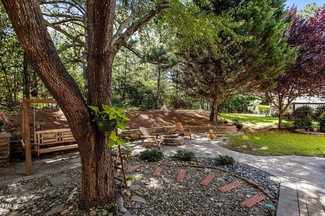 308 Sutton Glen Dr, Apex, NC 27523 - view of green lawn with an outdoor fire pit and a patio area