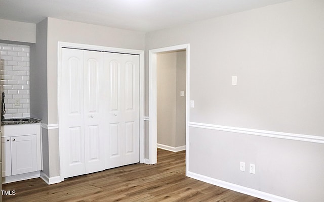 621 Reservoir St, Durham, NC 27703 - unfurnished bedroom with wood finished floors and a closet