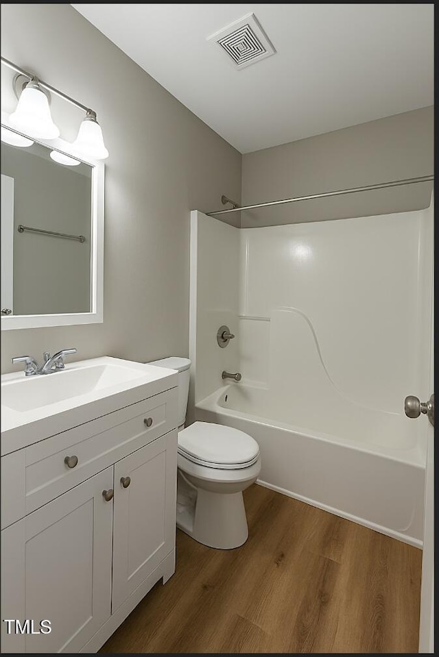 621 Reservoir St, Durham, NC 27703 - bathroom featuring vanity, wood finished floors, and shower / bathtub combination