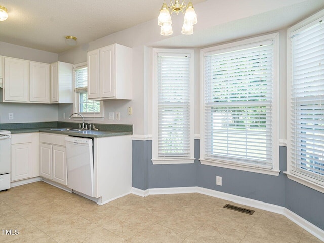 516 Yellow Berry, Wendell, NC 27591 - kitchen with white dishwasher, a chandelier, dark countertops, stove, and white cabinetry