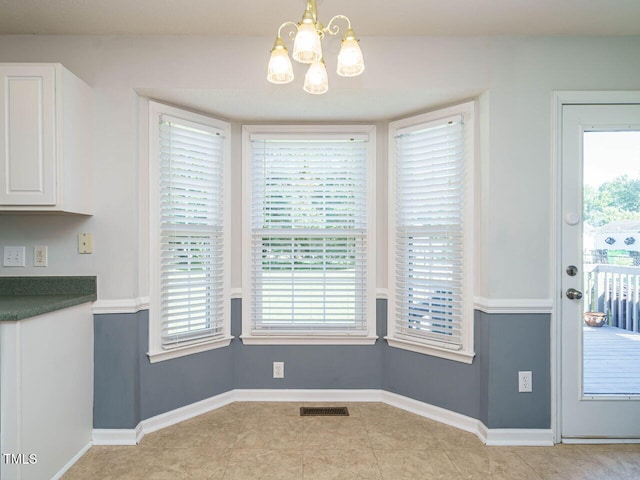 516 Yellow Berry, Wendell, NC 27591 - unfurnished dining area featuring a chandelier, plenty of natural light, and tile patterned floors
