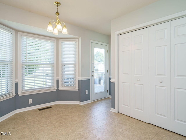 516 Yellow Berry, Wendell, NC 27591 - unfurnished dining area with a chandelier and light tile patterned flooring