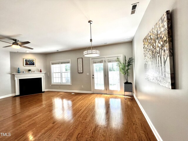 2069 White Pond Ct, Apex, NC 27523 - unfurnished living room with wood finished floors, ceiling fan, and a fireplace with flush hearth