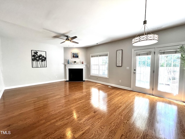 2069 White Pond Ct, Apex, NC 27523 - unfurnished living room featuring a ceiling fan, wood finished floors, and a fireplace with flush hearth