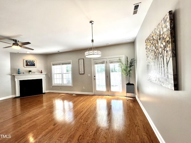 2069 White Pond Ct, Apex, NC 27523 - unfurnished living room with wood finished floors, ceiling fan, and a fireplace with flush hearth