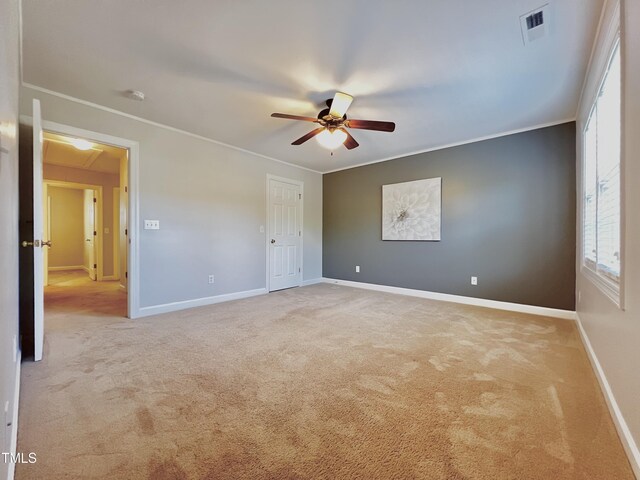 2069 White Pond Ct, Apex, NC 27523 - unfurnished bedroom featuring carpet floors, crown molding, multiple windows, attic access, and ceiling fan