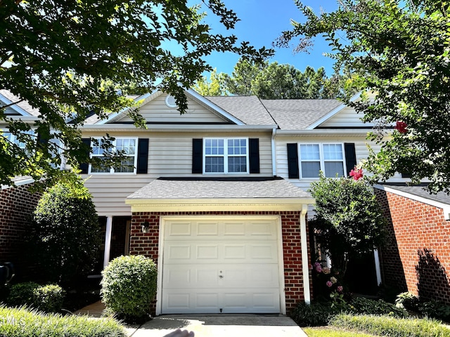 2069 White Pond Ct, Apex, NC 27523 - view of front facade with brick siding, roof with shingles, an attached garage, and driveway