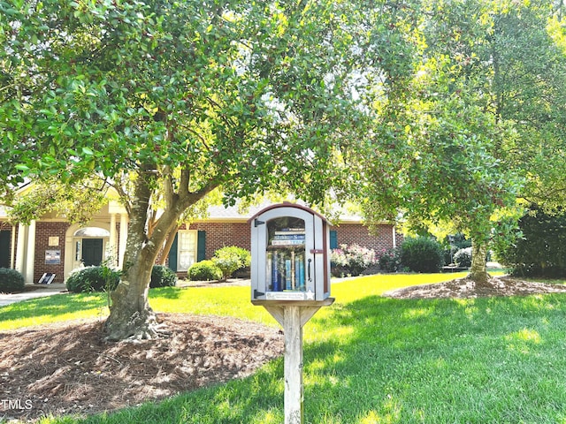2069 White Pond Ct, Apex, NC 27523 - obstructed view of property featuring brick siding and a front lawn