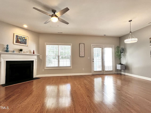 2069 White Pond Ct, Apex, NC 27523 - unfurnished living room featuring ceiling fan, healthy amount of natural light, wood finished floors, and a fireplace
