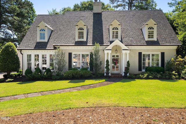 1610 Ridge Rd, Raleigh, NC 27607 - new england style home featuring brick siding, a chimney, and a front yard