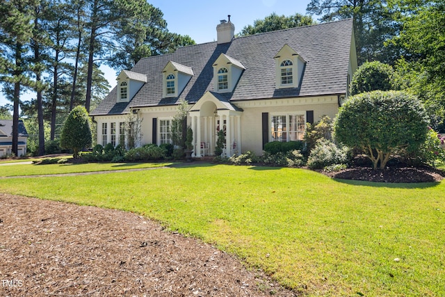 1610 Ridge Rd, Raleigh, NC 27607 - view of front facade featuring a chimney, brick siding, and a front lawn