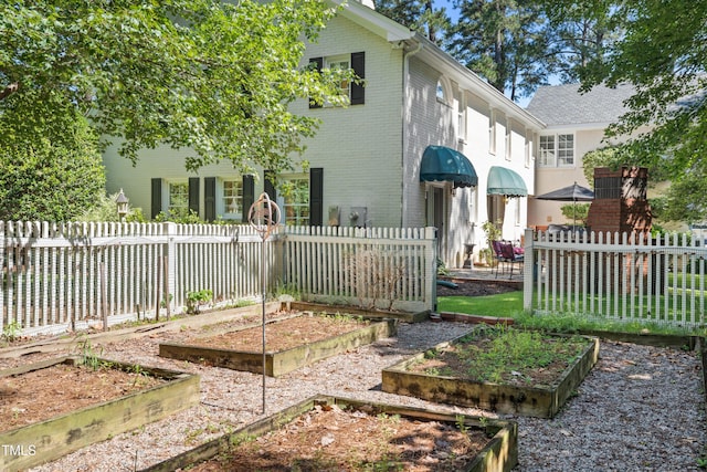 1610 Ridge Rd, Raleigh, NC 27607 - back of house with a vegetable garden and brick siding
