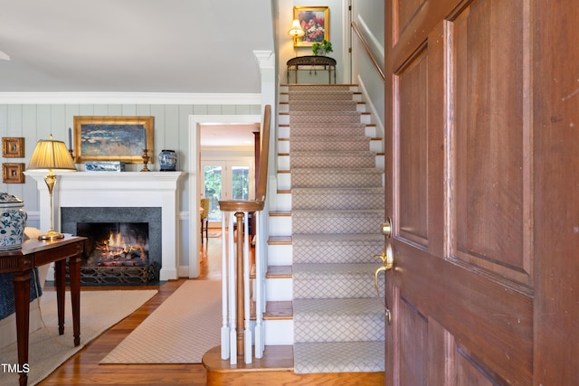 1610 Ridge Rd, Raleigh, NC 27607 - stairway with wood finished floors, a fireplace with flush hearth, and crown molding
