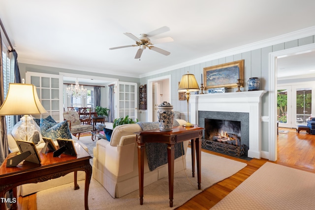 1610 Ridge Rd, Raleigh, NC 27607 - living area with ornamental molding, healthy amount of natural light, a chandelier, wood finished floors, and a ceiling fan