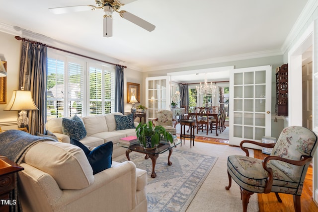 1610 Ridge Rd, Raleigh, NC 27607 - living room featuring healthy amount of natural light, a chandelier, ornamental molding, and a ceiling fan