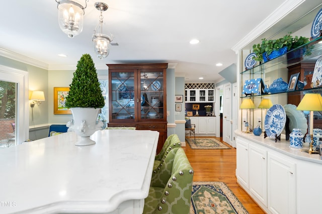 1610 Ridge Rd, Raleigh, NC 27607 - dining space featuring light wood-type flooring, crown molding, recessed lighting, and a chandelier