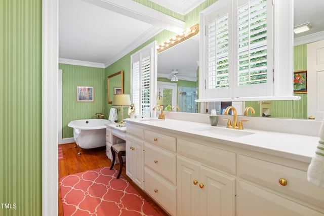 1610 Ridge Rd, Raleigh, NC 27607 - bathroom featuring ornamental molding, double vanity, a stall shower, a freestanding tub, and wood finished floors