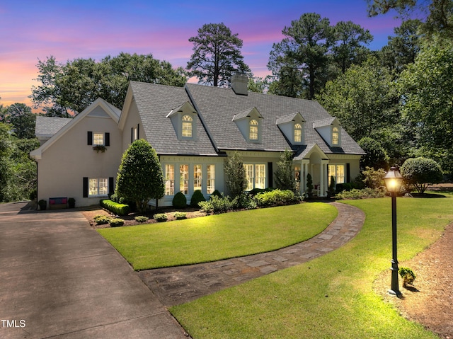 1610 Ridge Rd, Raleigh, NC 27607 - view of front of property with a front yard, a chimney, stucco siding, and concrete driveway