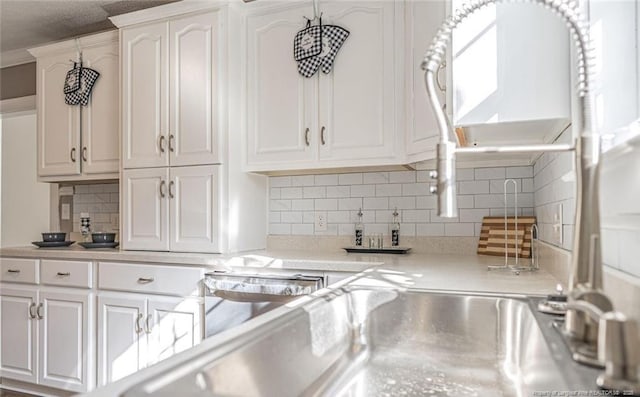 817 Aberdeen Rd, Laurinburg, NC 28352 - kitchen featuring light countertops, white cabinets, and backsplash
