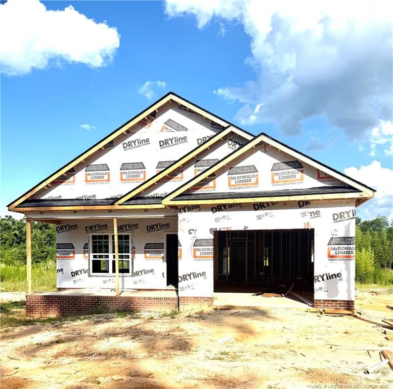 604 Cypress St, Roseboro, NC 28382 - property under construction featuring covered porch and a garage