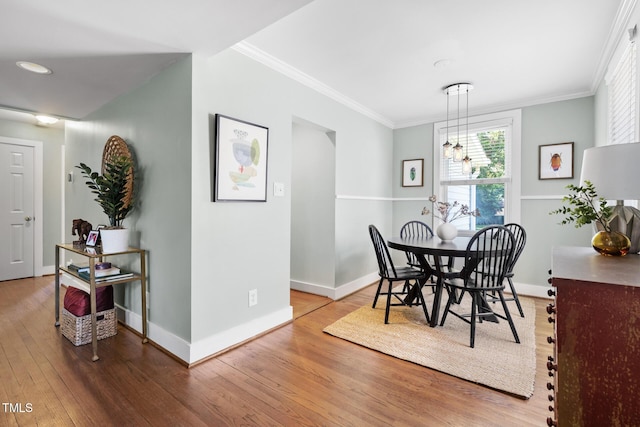 2804 Barmettler St, Raleigh, NC 27607 - dining area featuring wood finished floors, crown molding, and a chandelier