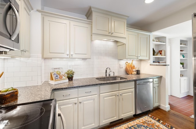 2804 Barmettler St, Raleigh, NC 27607 - kitchen featuring stainless steel appliances, dark stone counters, backsplash, open shelves, and dark wood finished floors