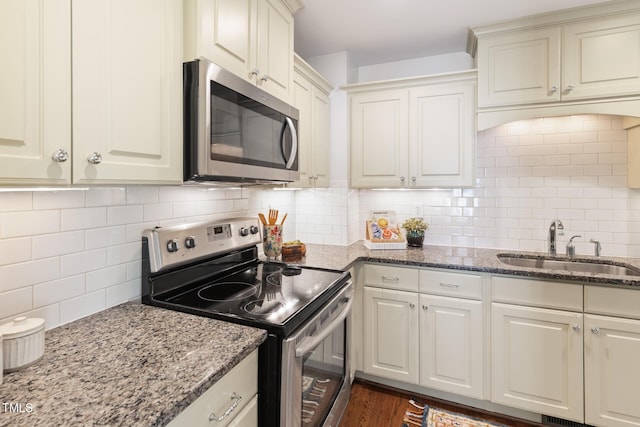 2804 Barmettler St, Raleigh, NC 27607 - kitchen with stainless steel appliances, backsplash, and light stone counters
