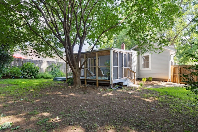 2804 Barmettler St, Raleigh, NC 27607 - back of property with a sunroom, a fenced backyard, and a chimney