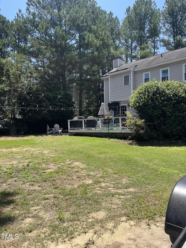 4117 Mangrove Dr, Raleigh, NC 27616 - view of green lawn with a wooden deck