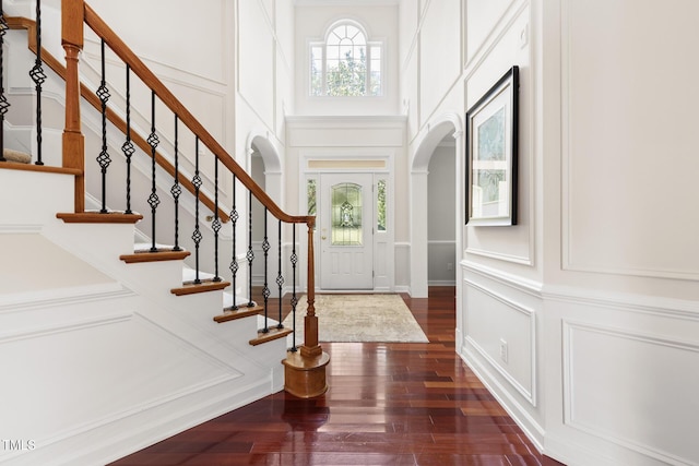 5106 Stockton Way, Durham, NC 27707 - entryway featuring a decorative wall, arched walkways, dark wood-style floors, stairway, and a high ceiling