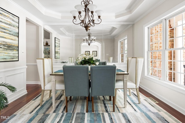 5106 Stockton Way, Durham, NC 27707 - dining space with a chandelier, healthy amount of natural light, wood finished floors, crown molding, and wainscoting