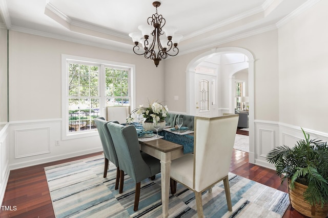 5106 Stockton Way, Durham, NC 27707 - dining space with arched walkways, wood finished floors, a chandelier, crown molding, and a wainscoted wall