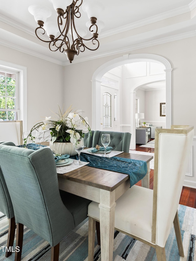 5106 Stockton Way, Durham, NC 27707 - dining area featuring arched walkways, crown molding, wood finished floors, and a chandelier